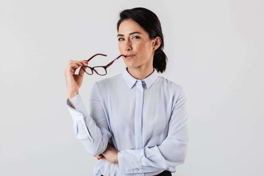 Woman holding reading glasses