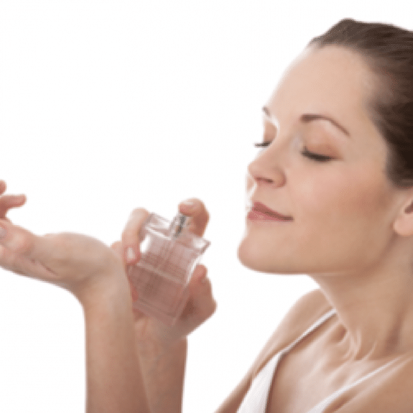 Woman smelling perfume on her wrist