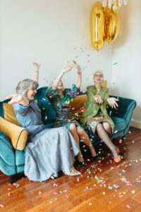 Older women sitting on couch celebrating what to wear when you have retired